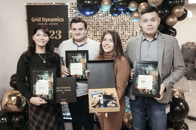 Grid Dynamics employees receiving 2023 annual awards during a company event.