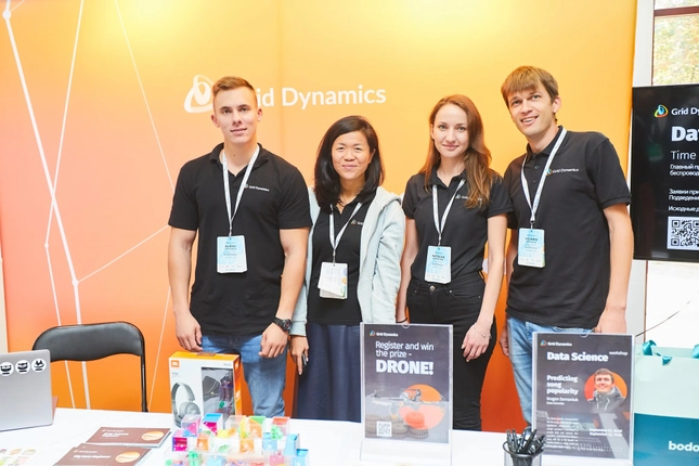 Grid Dynamics team members at a conference booth.
