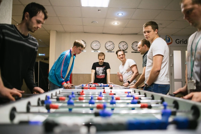 Grid dynamics employees playing foosball
