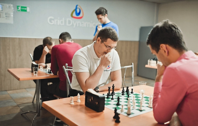 Grid Dynamics employees playing chess during a friendly tournament.