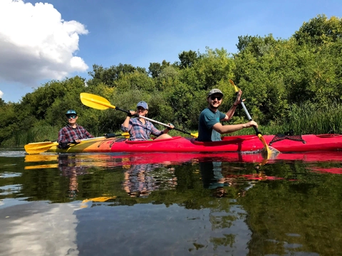 Group kayaking on a calm river