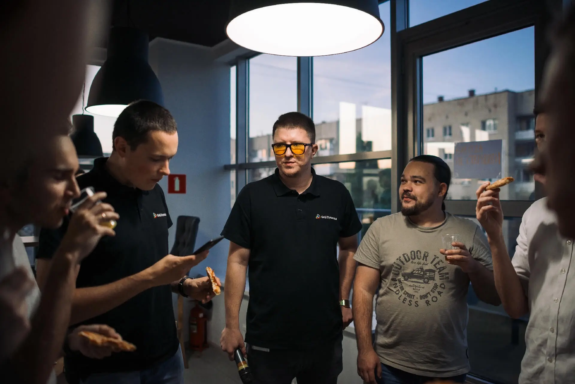 Group of people eating and socializing at an indoor event.