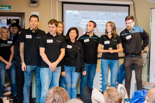 Group of participants standing at a hackathon event.